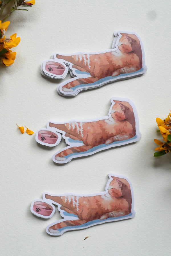 Three ginger cat stickers laid out on a cream background