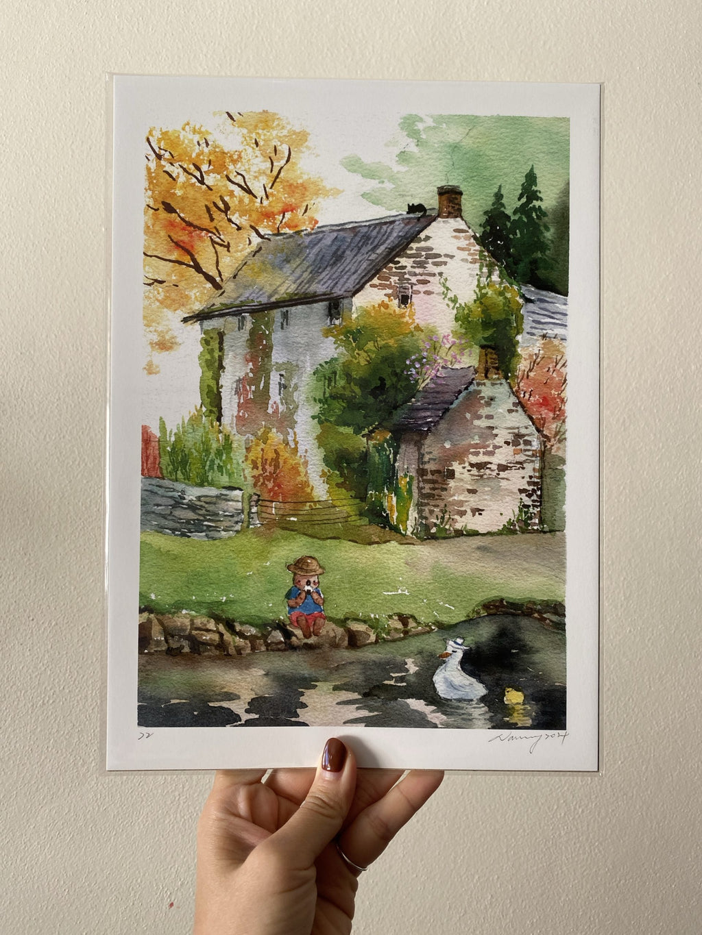 Watercolour illustration of Mr. Otter picnicking beside a cabin with ducks on the pond