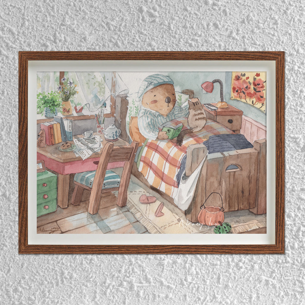 Mr. Otter in bed with kitty print framed on a shelf
