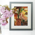 No Kitty No! naughty cat biting plants watercolour art print shown framed on a wall