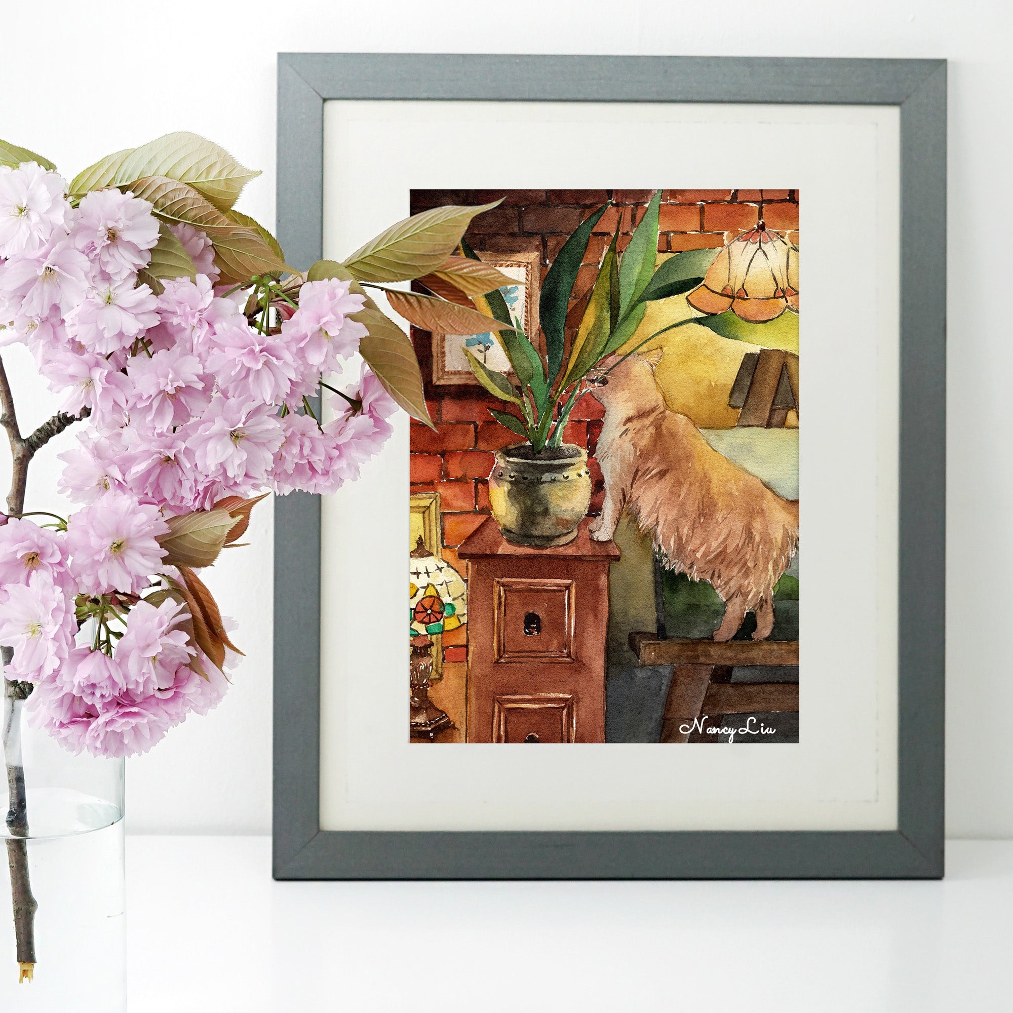 No Kitty No! naughty cat biting plants watercolour art print shown framed on a wall