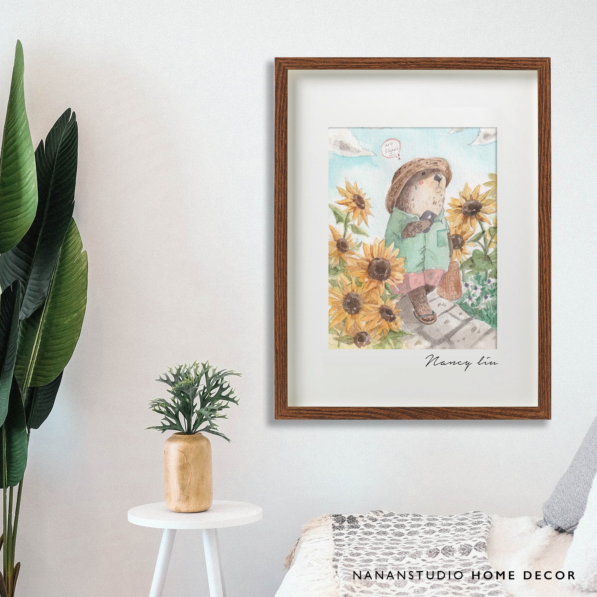 Mr. Otter arrival print in a wooden frame on a wall