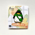 Penguin postman enamel pin in a green cap, green cape and mail bag, on an illustrated Nanan Studio backing card